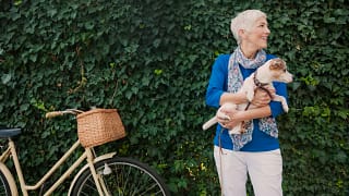 mature woman holding dog.jpg