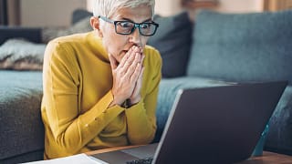 mature woman looking at computer in shock.jpg