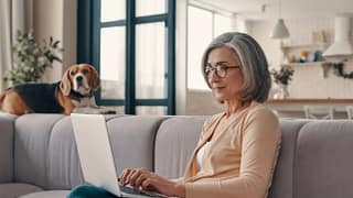 older woman laptop dog in background gettyimages .jpg