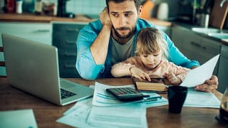 parent with toddler laptop and paperwork IjW.width .jpg