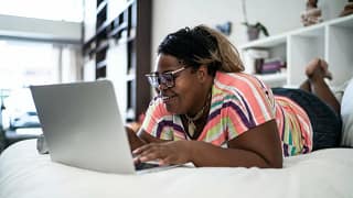 person on bed with laptop Hpu.width .jpg