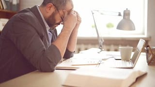 stressed man working at desk mjoTo.width .jpg