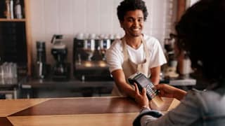 woman paying cafe cashier with credit card.width .jpg
