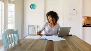 woman with laptop and notes at home RFqPxm.width .jpg