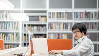 Male college student library laptop books tZT.width .jpg