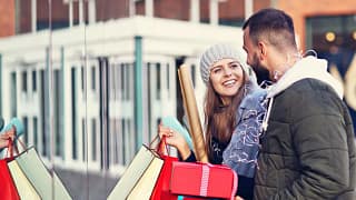 Smiling couple holiday shopping NpoPJs.width .jpg