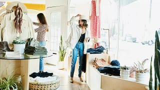Woman trying on hat while boutique shopping w.width pnoSR.jpg
