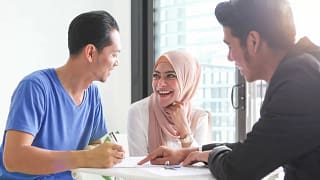 Young couple signs paperwork with agent TTMv.width .jpg