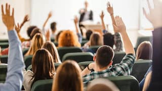 college students raising hands in lecture F.width .jpg