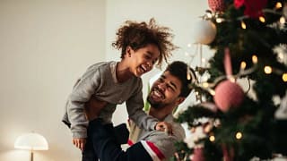 dad and daughter decorating christmas tree.width .jpg