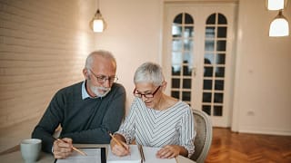 elderly couple with notebook and calculator c.width .jpg