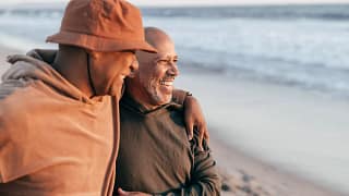 getty two people smiling hugging on the beach.jpg