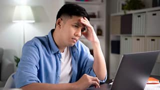 man s laptop stressed holding head gettyimages .jpg