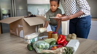 mother and son opening meal service kit.width .jpg