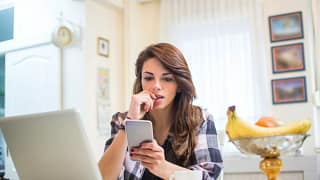 nervous young woman with phone and laptop.width .jpg