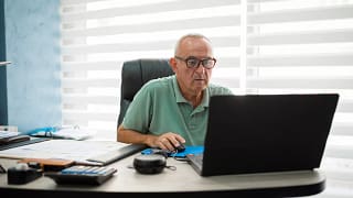 older man desk serious gettyimages .jpg