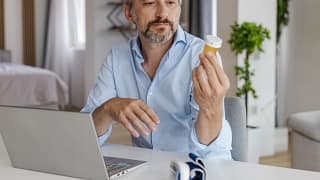 person looking at prescription bottle.jpg