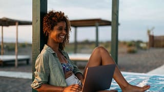 person at beach with laptop ZozlRL.width .jpg