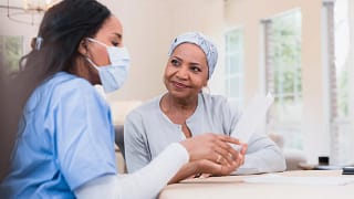 senior talking with healthcare worker wearing mask.jpg