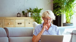 senior woman holding laptop gettyimages .jpg