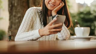 smiling person using smartphone TFngkG.width .jpg