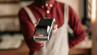 waiter holding credit card reader.width .jpg