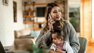 woman on phone with baby on lap LfSMd.width .jpg