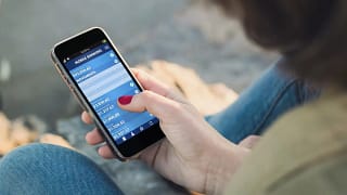 woman on smart phone using budgeting apps hce.width .jpg
