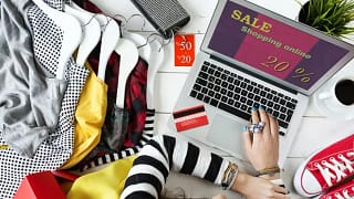 woman online shopping on laptop with clothes .width .jpg