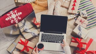 woman with laptop and holiday gifts.width .jpg