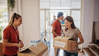 Woman carrying box marked Donations gPzKqVh n.width .jpg