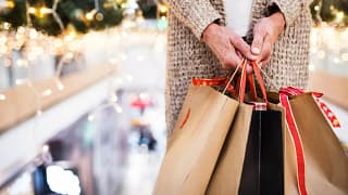 Woman holding shopping gift bags mPdZbn.width .jpg