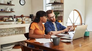 couple reviewing bills on laptop.width .jpg