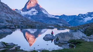 hiker in front of matterhorn mountain lake em.width .jpg