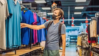 man wearing mask and shopping in clothing sto.width .jpg