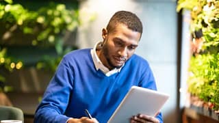 man with notebook and tablet GEhIZXm.width .jpg