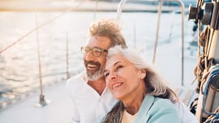 mature couple sitting on a boat smiling.jpg