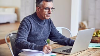 middle aged man notes laptopgettyimages .jpg