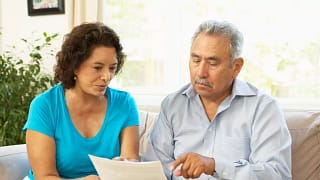 senior couple pointing at document.jpg