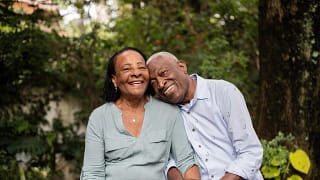 smiling couple sitting outdoors.jpg
