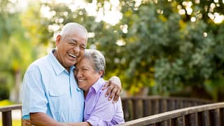 two older people standing outside hugging.jpg