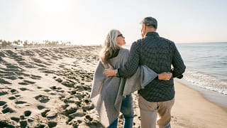 two people walking on the beach hugging.jpg