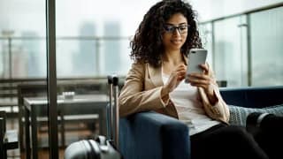 woman with suitcase and phone lalcl.width .jpg