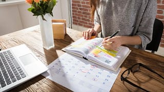 women at desk with calendar and planner.width .jpg