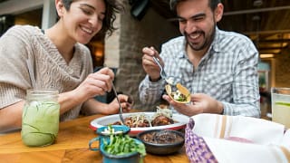 Couple sharing a meal in an outdoor space. Ae.width .jpg