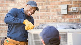 HVAC technicians servicing an outdoor unit wa.width .jpg