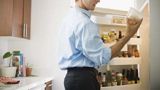 Man checking out leftovers from fridge. LPHTv.width .jpg