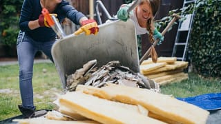 Two women dumping home renovation scraps in a.width WSoZror.jpg