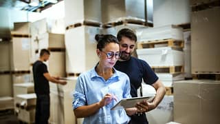 Workers in warehouse surrounded by boxes. YAT.width .jpg