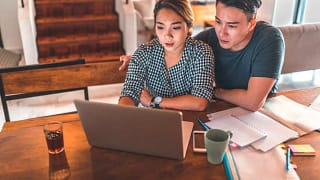Young couple at table with laptop bLGhsGN.width iGaUKue.jpg